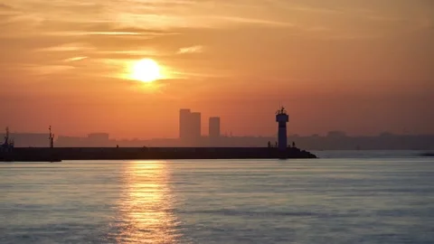 Sun is setting down behind buildings and lighthouse in Istanbul time lapse Stock Footage 141513325