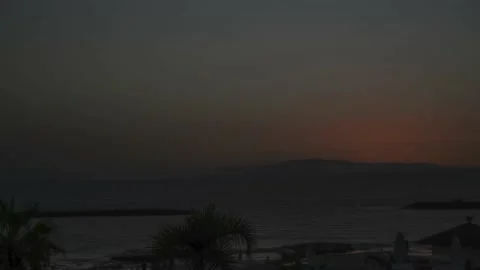 Sun setting down behind mountains in Ten... | Stock Video | Pond5