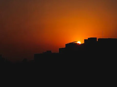 Sun is setting down behind the silhouette buildings Dhaka, Bangladesh Stock Photos