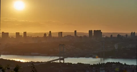 Sun is setting down behind skyscrapers and Bosphorus Bridge, Istanbul Stock Footage 131300534
