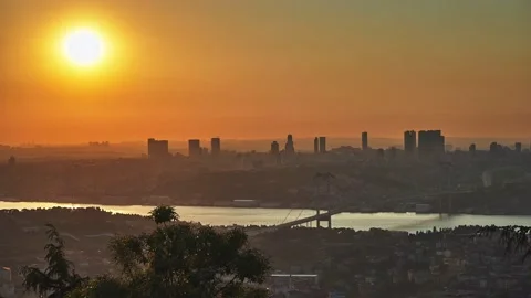 Sun is setting down behind skyscrapers and Bosphorus Bridge, Istanbul Stock Footage 131301132