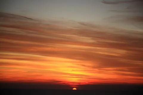 Sun setting down into the horizon Stock Photos