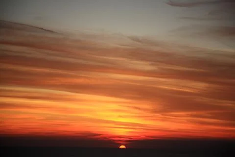 Sun setting down into the horizon Stock Photos