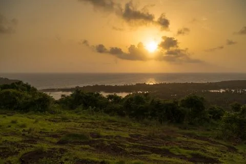 Sun setting down over the horizon Stock Photos