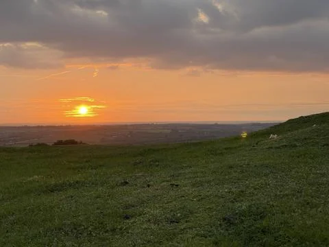 Sun setting down scenery in the hills valley Stock Photos
