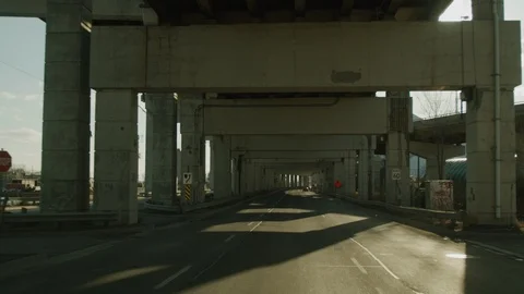 Sun setting driving under the Gardiner Expressway Toronto infrastructure Video stock 127569248