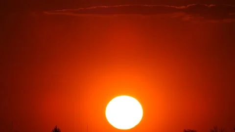 The sun is setting during a red sunset in a clear sky Stock Footage 248902790