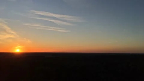Sun setting on flat horizon Stock Footage