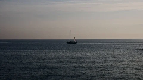 Sun setting in the horizon on a beach, pink sky, ocean Stock Footage 115330387