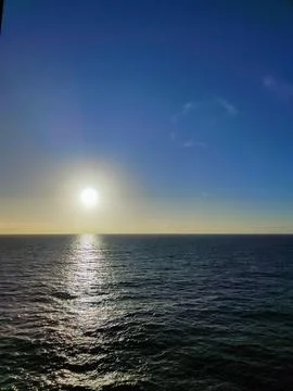 Sun setting on the horizon over the ocean Stock Photos