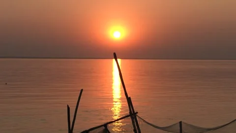 Sun setting on the horizon of a vast tropical river. Video stock 333639178