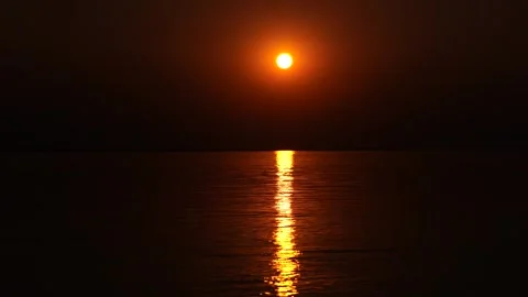 Sun setting on the horizon of a vast tropical river. Video stock 333639262