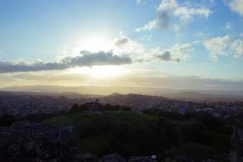 Sun setting into the horizon. The view is from high ground green mountain Stock-Fotos