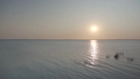 The sun setting with its reflection on the ocean Stock Footage 240924703