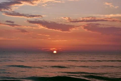 Sun setting just in middle of a ocean in Goa Stock Photos