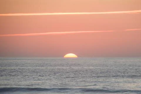 Sun setting on the ocean 스톡 사진