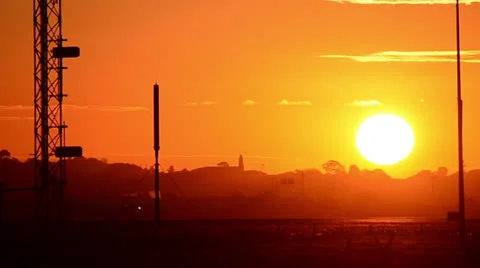 Sun Setting over an airport with jets taxing in forground 160GYAP 5981 PAL Stock Footage 26553478