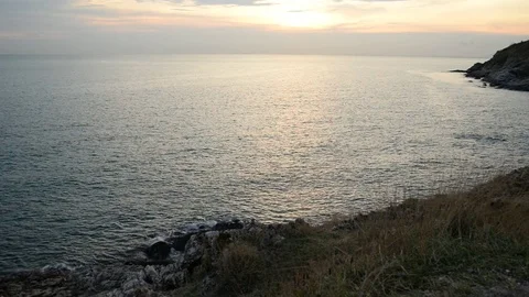 Sun setting over blue ocean coastline Stock Footage 75850501