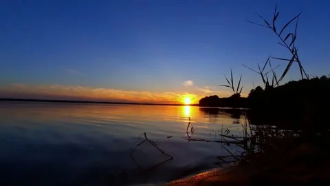The sun is setting over a body of water, a picture, romanticism Stock Footage 280892291