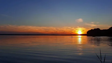 The sun is setting over a body of water Stock Footage 280892299
