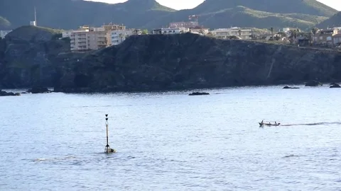Sun setting over Cabo de palos seascape as a vessel sail through Vídeos de archivo 130894848