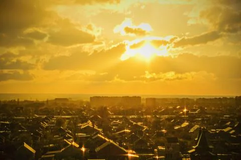 The sun is setting over city. Rain at sunset. Stock Photos