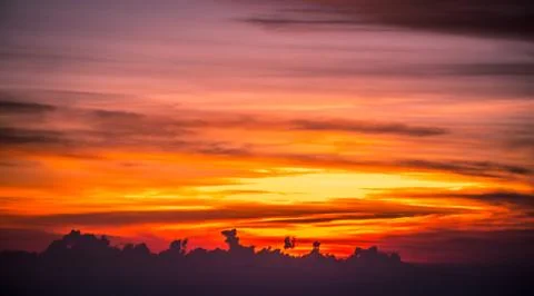 Sun setting over clouds views from airplane Stock Photos
