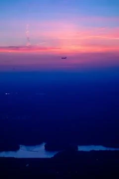 Sun setting over clouds views from airplane Stock Photos