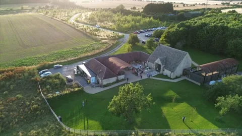 Sun Setting Over Converted Barn, Wedding Guests Video stock 246327285