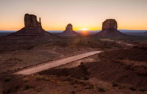 The Sun Setting Over a Desert Landscape Stock Photos