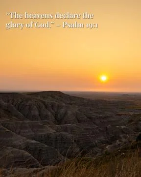 The sun is setting over a desert landscape Stock Photos