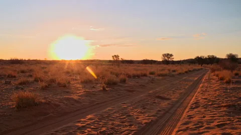 The sun setting over a desert road Stock Footage 298203277