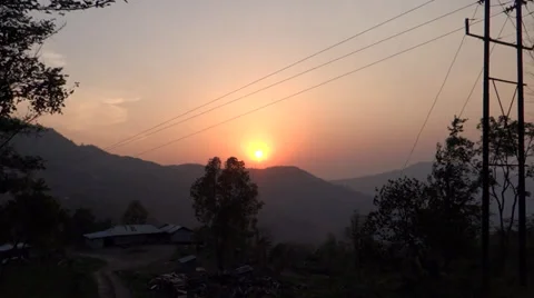 Sun is setting over a distant range of hills in a rural setting-1 Stock Footage 38122161
