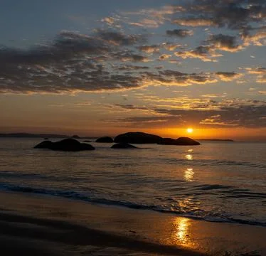 Sun Setting Over an Empty Beach Stock Photos