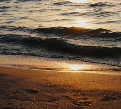 Sun Setting Over an Empty Beach Stock Photos