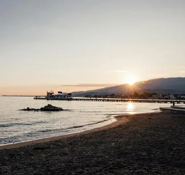 Sun Setting Over an Empty Beach Stock Photos