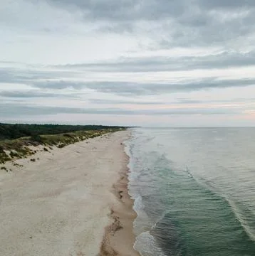 Sun Setting Over an Empty Beach Stock Photos