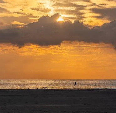 Sun Setting Over an Empty Beach Stock Photos