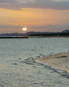 Sun Setting Over an Empty Beach Stock Photos