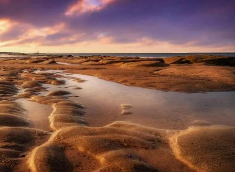Sun Setting Over an Empty Beach Stock Photos
