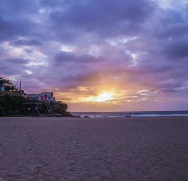 Sun Setting Over an Empty Beach Stock Photos