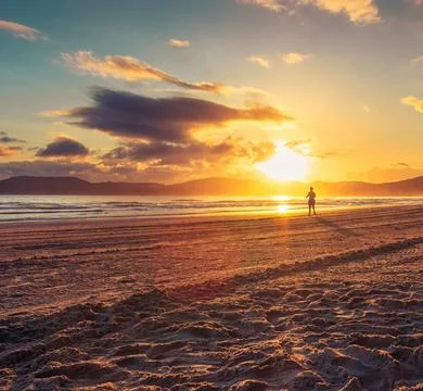 Sun Setting Over an Empty Beach Stock Photos