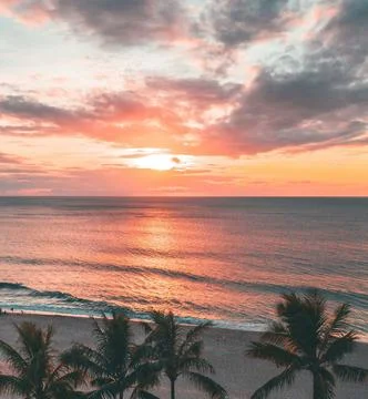 Sun Setting Over an Empty Beach Stock Photos