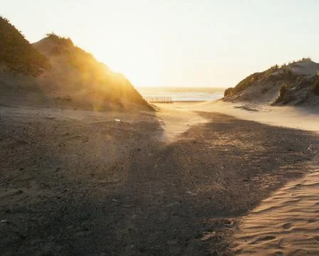Sun Setting Over an Empty Beach Stock Photos