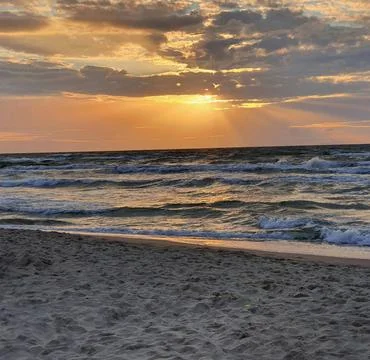 Sun Setting Over an Empty Beach Stock Photos