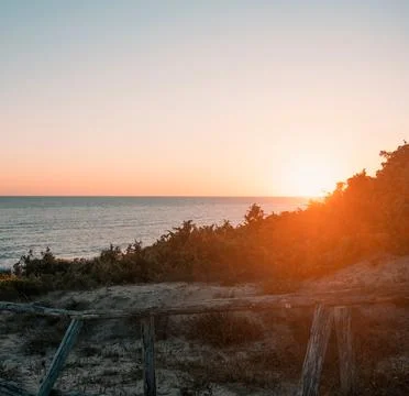 Sun Setting Over an Empty Beach Stock Photos