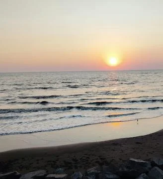 Sun Setting Over an Empty Beach Stock Photos