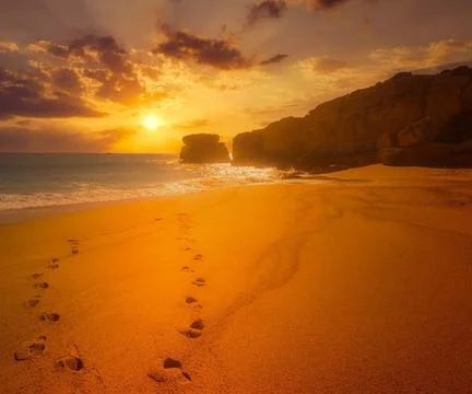 Sun Setting Over an Empty Beach Stock Photos