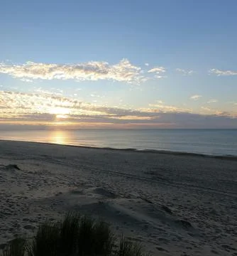 Sun Setting Over an Empty Beach Stock Photos