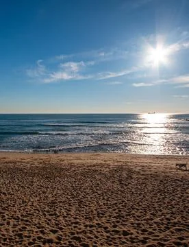 Sun Setting Over an Empty Beach Stock Photos